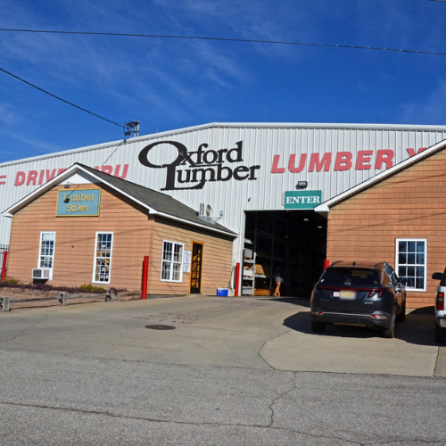 Front view of a lumber yard with a large sign 