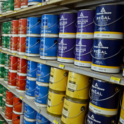 Benjamin Moore PaintA bright store display of various orange and white power tools, including chainsaws and trimmers, neatly arranged on shelves and racks in a hardware store.