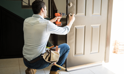 Contractor installing a door lock