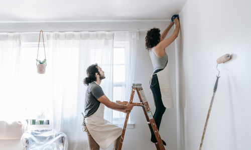 Couple painting a room